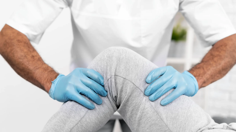 male-physiotherapist-checking-woman-s-knee-mobility