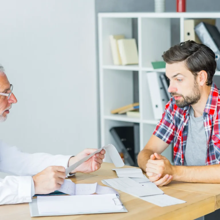 senior-doctor-talking-with-patient-office
